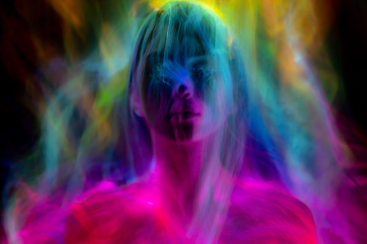 A vibrant abstract image of a woman's silhouette engulfed in colorful swirling lights.